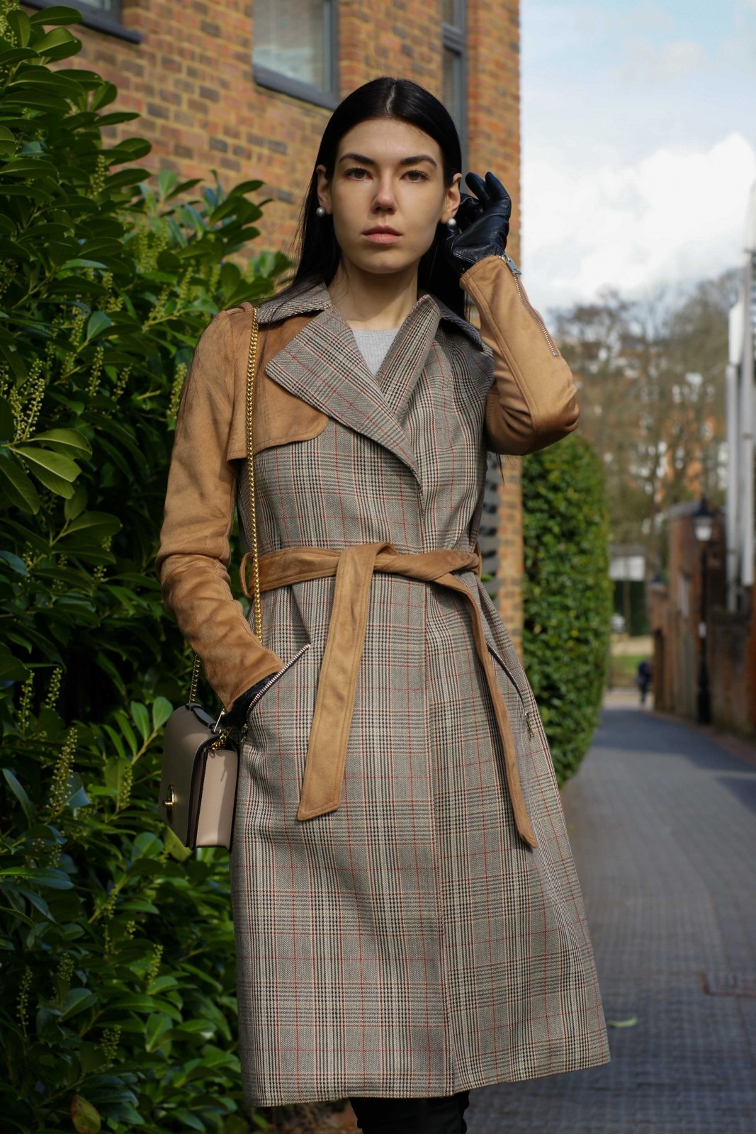 Brunette girl witha light brown check trench coat