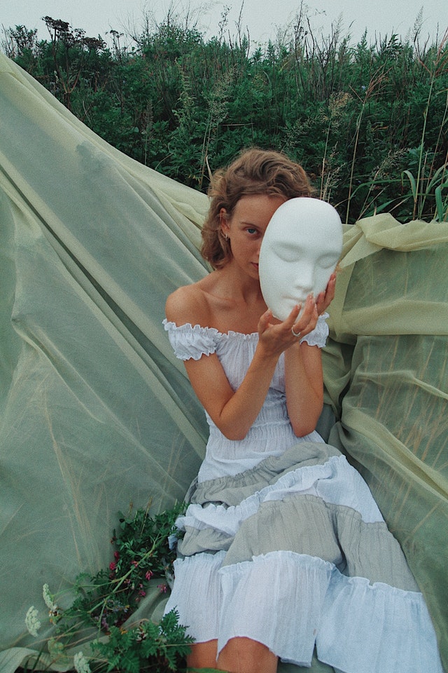 The Art of Eccentricity and What It Means for Women Girl with a White Dress and Mask